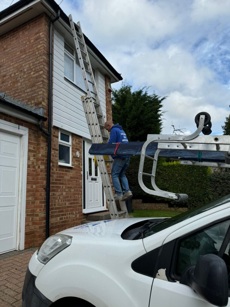 Roofer is climbing on the ladder